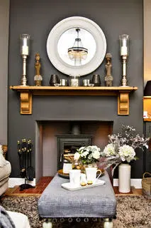 Fireplace, footstool, flowers, and ornament arrangement inside the therapy room.